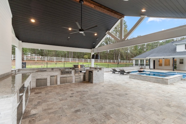 view of patio with area for grilling and ceiling fan