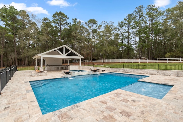 view of pool featuring an in ground hot tub, area for grilling, a patio, and pool water feature