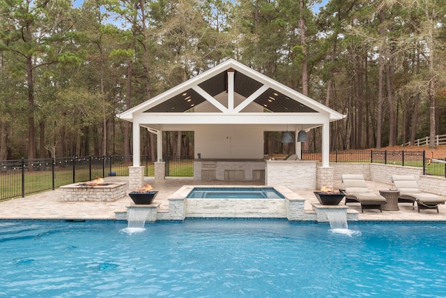 view of swimming pool featuring a gazebo, a patio area, an in ground hot tub, and pool water feature