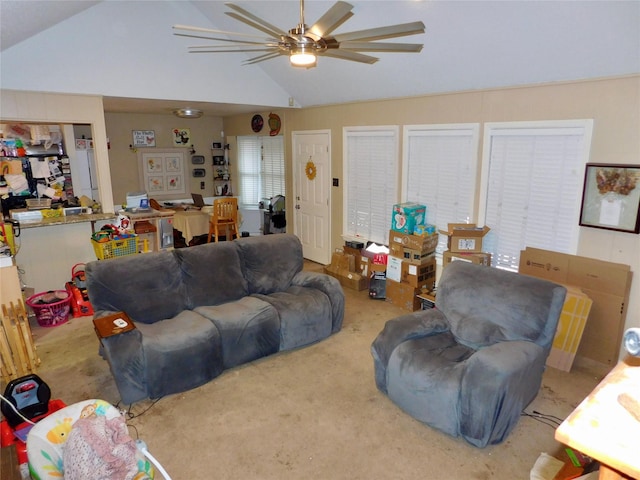 living room with carpet flooring, ceiling fan, and vaulted ceiling