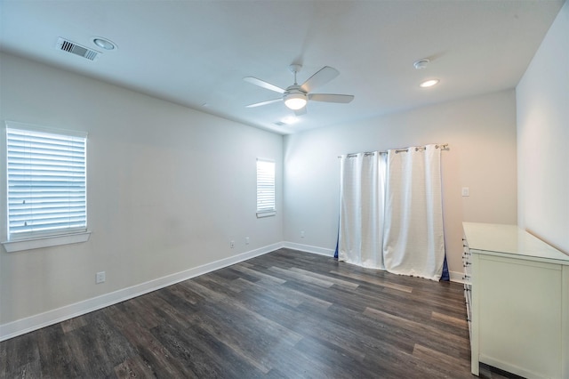 empty room with dark hardwood / wood-style floors and ceiling fan