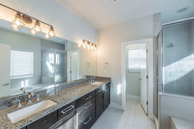 bathroom featuring vanity and a shower with door