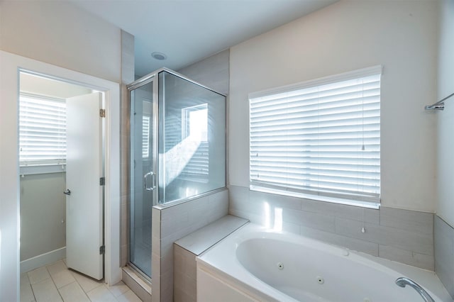 bathroom with tile patterned flooring and separate shower and tub