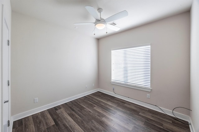 spare room featuring ceiling fan and dark wood-type flooring