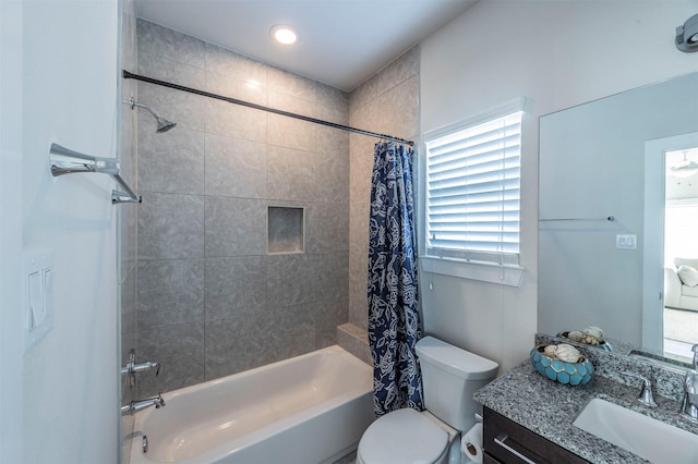 full bathroom with vanity, shower / bathtub combination with curtain, and toilet