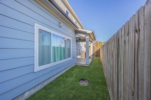 view of side of property with a lawn