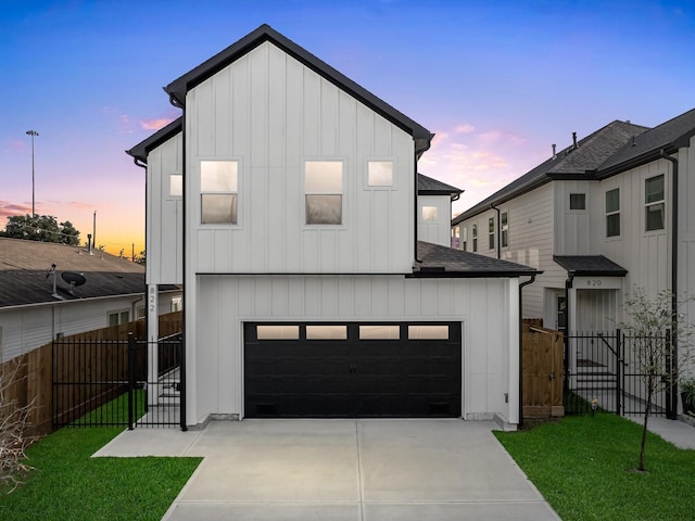 modern farmhouse style home featuring a lawn and a garage