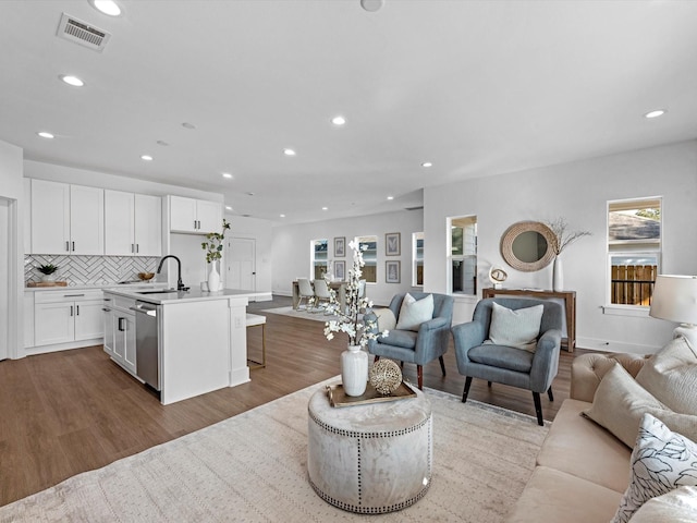 living room with sink and light hardwood / wood-style flooring