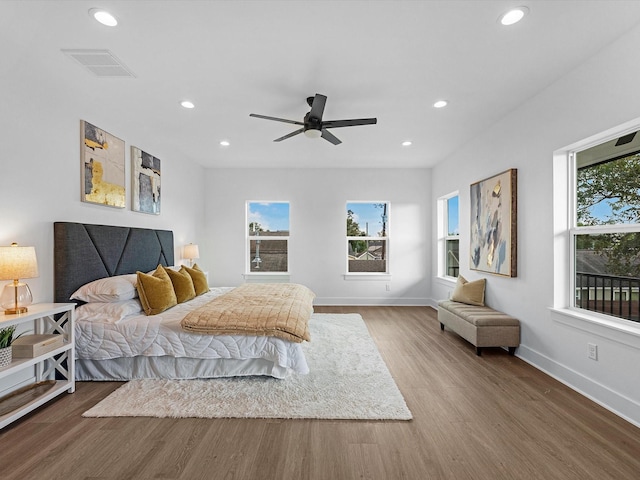 bedroom with ceiling fan and hardwood / wood-style flooring