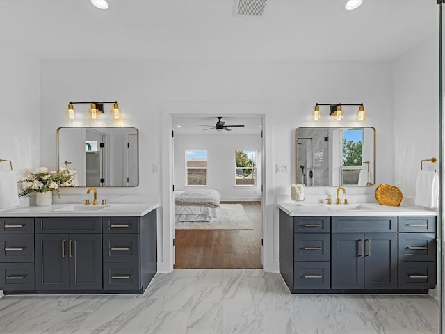 bathroom with a shower, ceiling fan, and vanity