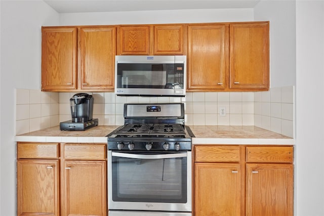 kitchen featuring decorative backsplash and appliances with stainless steel finishes