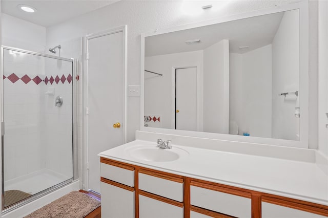 bathroom with vanity and an enclosed shower