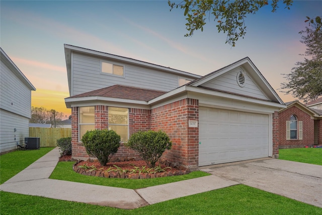 view of front of home featuring central AC unit and a garage