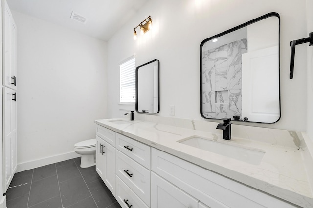 bathroom featuring tile patterned flooring, vanity, and toilet