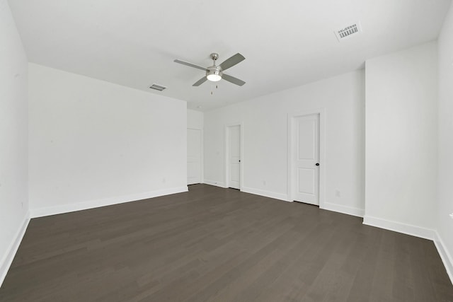 empty room with ceiling fan and dark hardwood / wood-style floors