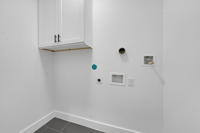 clothes washing area featuring washer hookup, dark tile patterned floors, cabinets, and hookup for an electric dryer