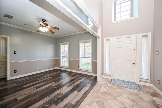 entrance foyer with ceiling fan, ornamental molding, and light hardwood / wood-style flooring