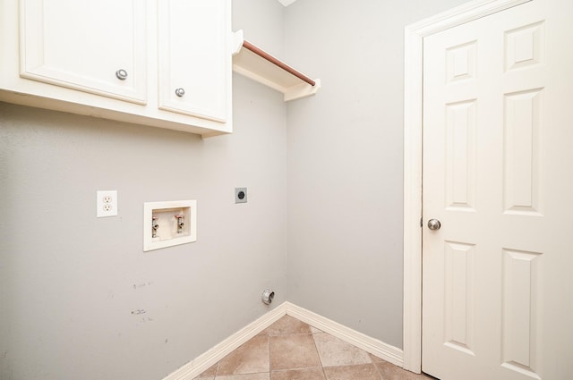 laundry area with hookup for an electric dryer, hookup for a washing machine, light tile patterned floors, and cabinets