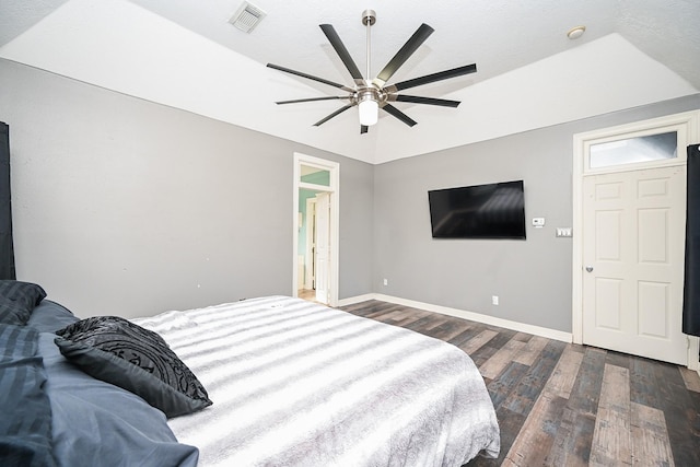 bedroom with ceiling fan, dark hardwood / wood-style floors, and lofted ceiling