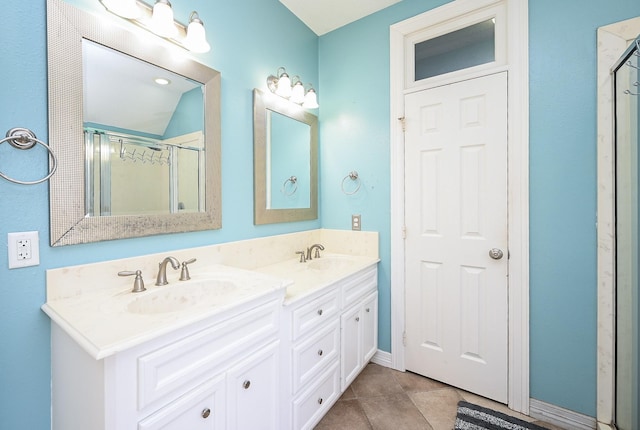 bathroom featuring tile patterned flooring, vanity, and a shower with shower door