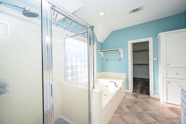 bathroom featuring lofted ceiling and independent shower and bath