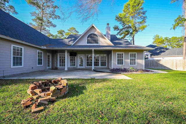 back of house with a patio, an outdoor fire pit, and a lawn