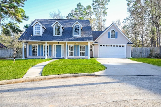 new england style home with a porch, a front yard, and a garage