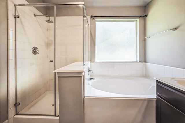 bathroom featuring vanity, separate shower and tub, and plenty of natural light