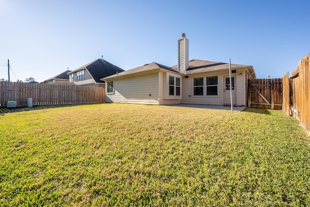 rear view of property featuring a yard