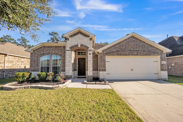 view of front of home with a garage and a front lawn