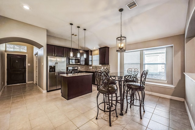 dining area with a notable chandelier and light tile patterned floors