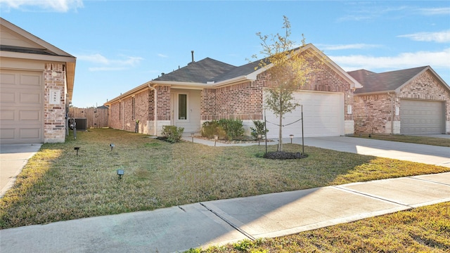 ranch-style house with a garage, central air condition unit, and a front yard