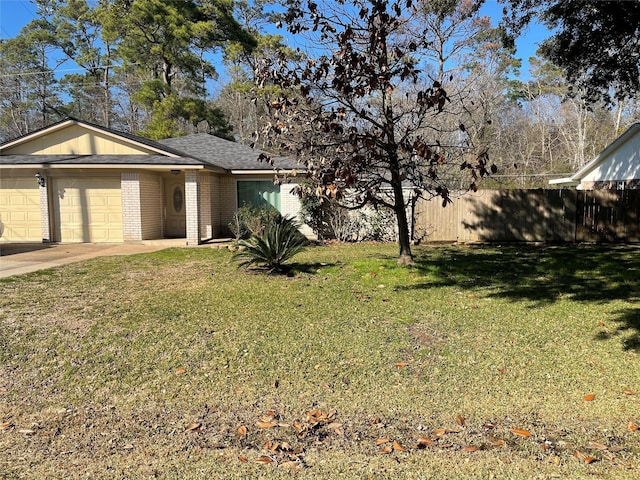 view of front of home with a garage and a front lawn