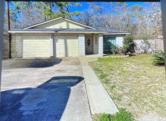 ranch-style home with a front lawn and a garage