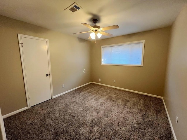 spare room with carpet and ceiling fan