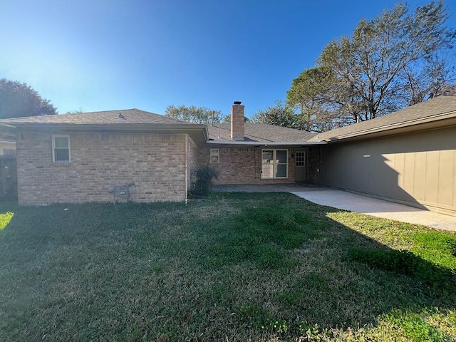 rear view of house featuring a yard