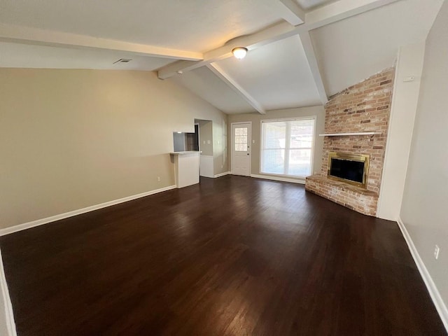 unfurnished living room featuring vaulted ceiling with beams, dark hardwood / wood-style flooring, and a brick fireplace