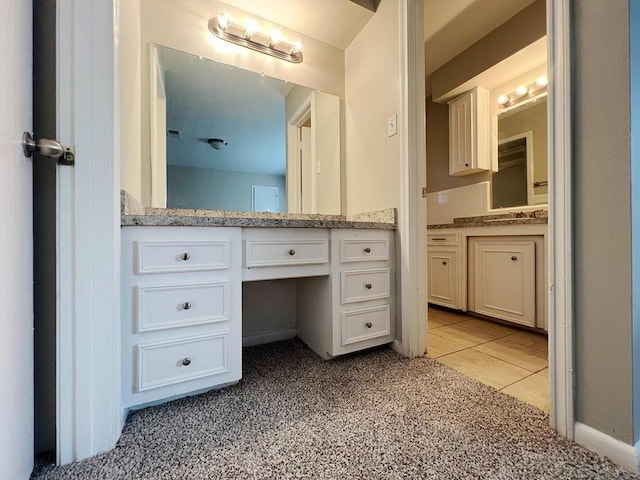 bathroom with tile patterned flooring and vanity