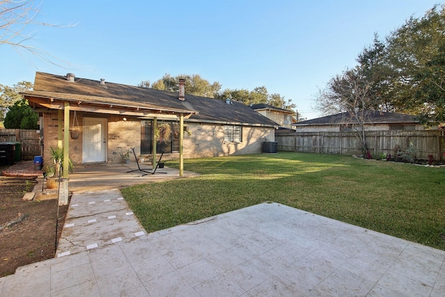 back of property with a lawn and a patio area