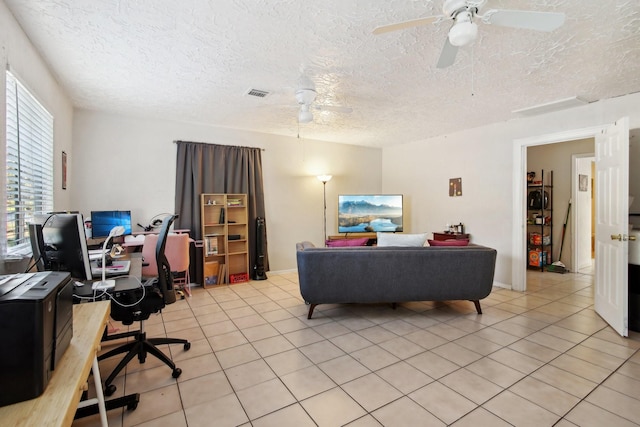 living room with light tile patterned floors, a textured ceiling, and ceiling fan