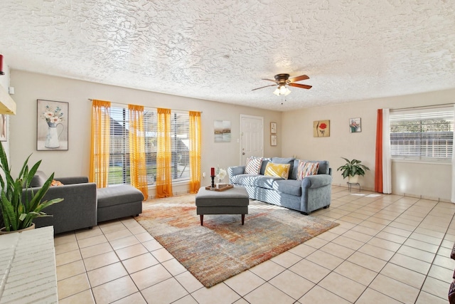 living room with light tile patterned floors, a textured ceiling, and ceiling fan