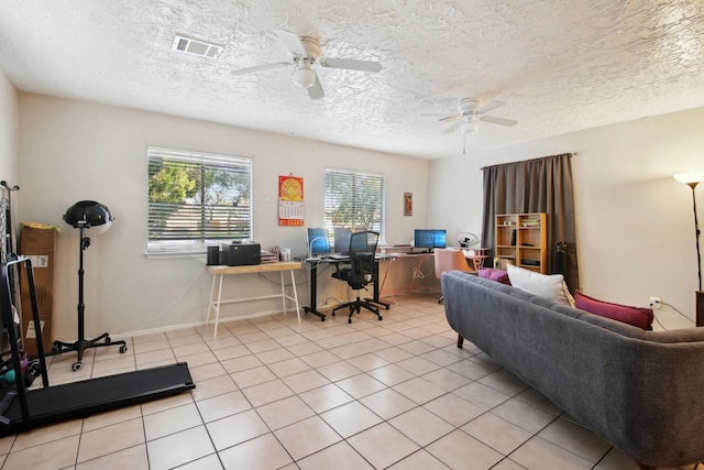 office space featuring ceiling fan, light tile patterned floors, and a textured ceiling