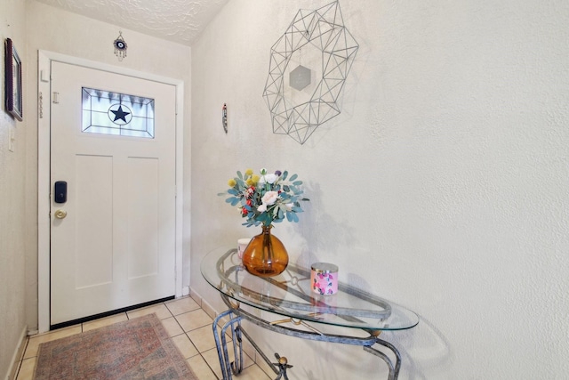 tiled foyer entrance with a textured ceiling