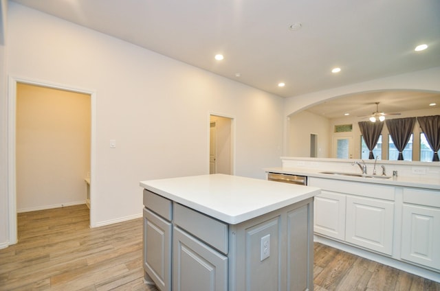 kitchen featuring a center island, white cabinets, sink, ceiling fan, and gray cabinets