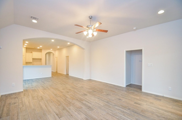 unfurnished living room featuring ceiling fan, light hardwood / wood-style floors, and lofted ceiling