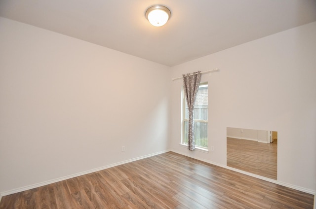 unfurnished room with hardwood / wood-style floors