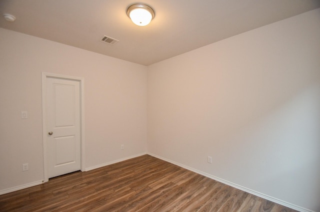 spare room featuring dark hardwood / wood-style floors