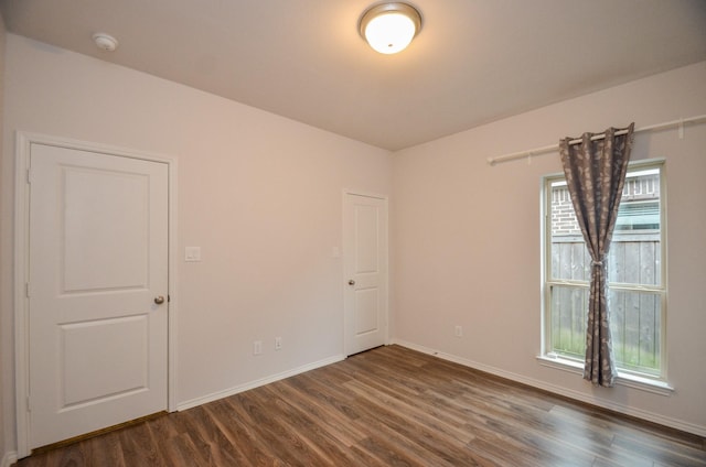 spare room with dark hardwood / wood-style floors