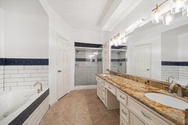 bathroom with separate shower and tub, tile patterned flooring, vanity, and a textured ceiling