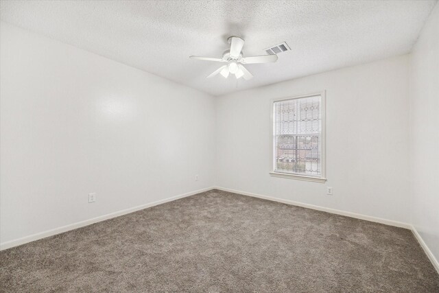 empty room featuring carpet flooring, a textured ceiling, and ceiling fan